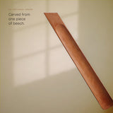 Close-up of the single continuous carved scoop and the beechwood grain