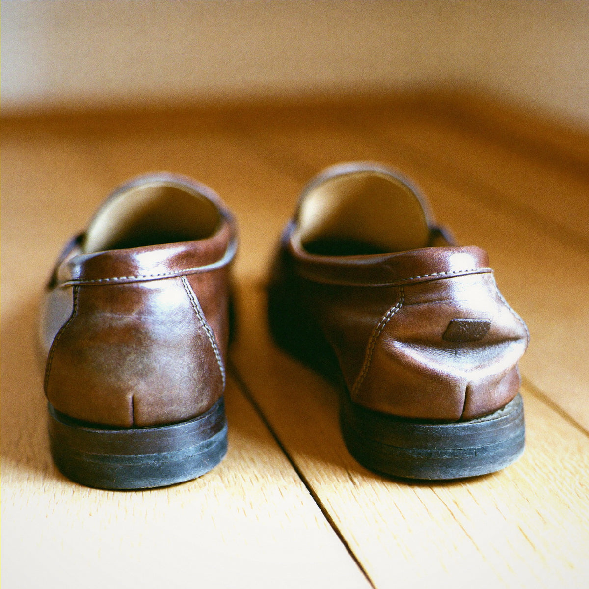 Leather shoes with heel backs crushed and folded down from being trodden on